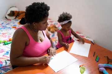 Black Mother And Daughter Drawing On The Table.