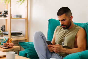 Serious young man with mobile phone