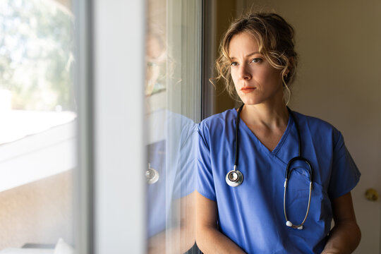Worried Nurse Observes Outside Life