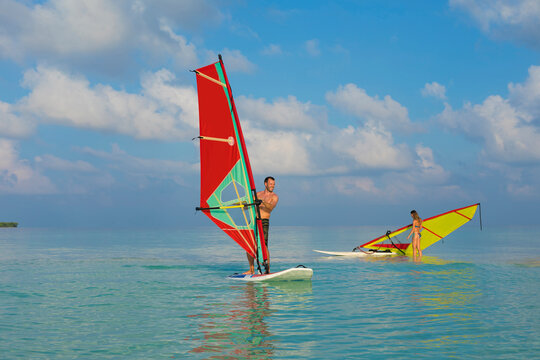 a couple windsurfing in the Maldives