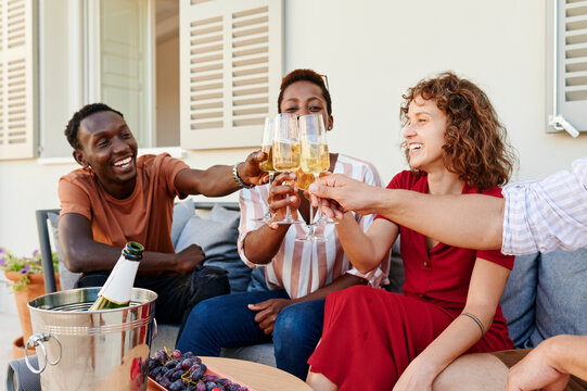 Diverse friends toasting together with champagne