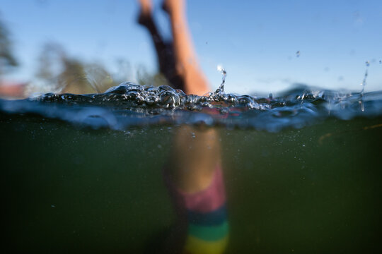 Soft focus image of girl in swimsuit doing handstand in ocean