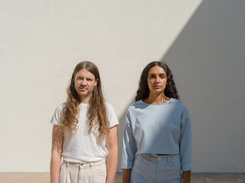 young couple in monochrome outfits in diagonal shadow