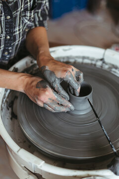 Female artisan makes ceramic products.