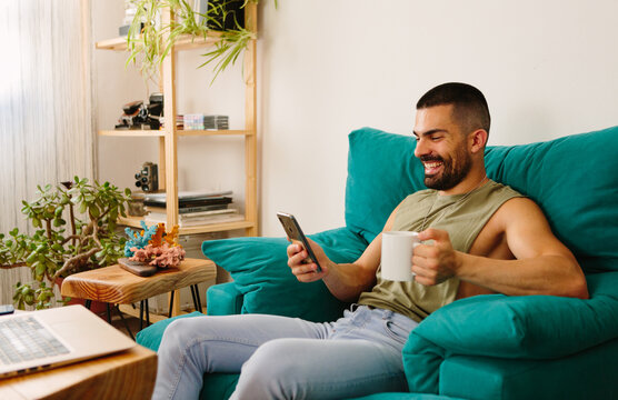 Happy young guy with mobile phone