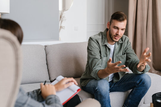 Worried man speaking with psychologist
