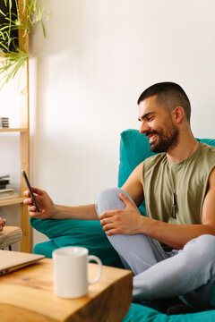 Happy young guy with mobile phone