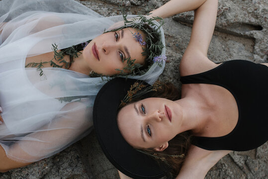 Two girls lie on the rock