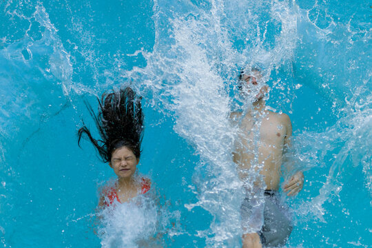 A young couple is falling into a pool in Singapore.