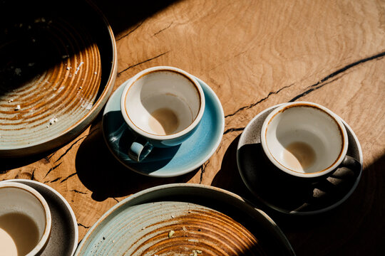 Top view of empty dishes and coffe cups on top of table