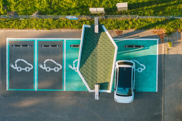 Drone aerial view of electric car parked in charging station