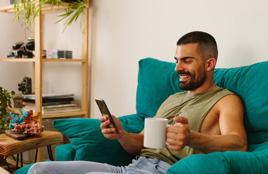 Happy young guy with mobile phone