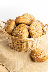 Cut bread. Fresh loaf of rustic traditional bread with wheat grain ear or spike plant on linen texture background. Rye bakery with crusty loaves and crumbs. Bio ingredients, very healthy seeds.