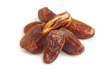Heap of dried dates with half isolated on white