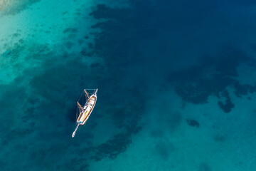 aerial view of sailboat in turquoise water