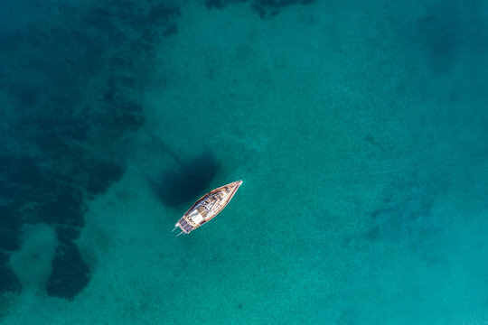 aerial view of sailboat in turquoise water