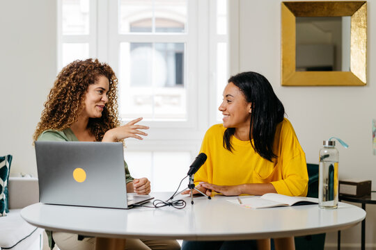 Ethnic women recording podcast together