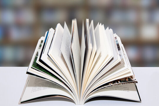 A Book Spread Out On The Table