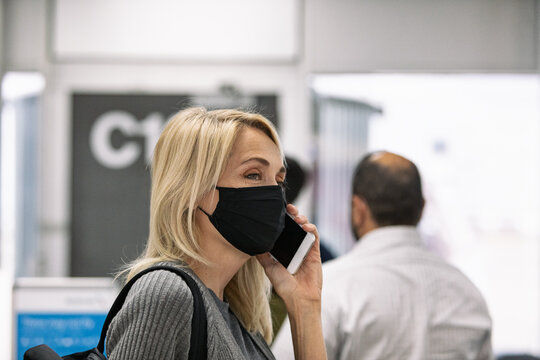 Travel: Woman Talks To Family While In Line At Airline Gate