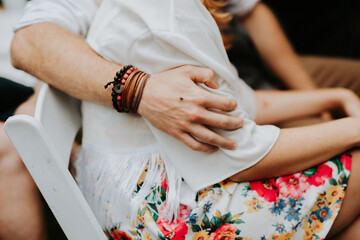 boy holding his arm around his girl and mosquito sitting on his hand