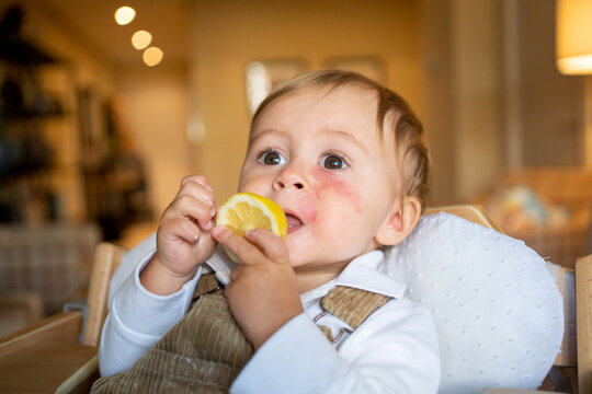 Little Baby Eating Lemon.