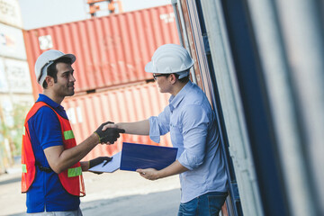 Obraz premium worker staff shaking hand for sucess working at Container. workers prepare export products. Container Shipping Logistics Engineering of Import Export Transportation Industry