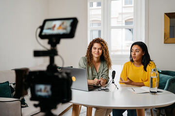 Ethnic women recording podcast together