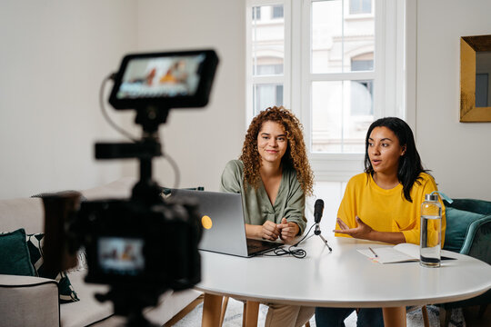 Ethnic women recording podcast together