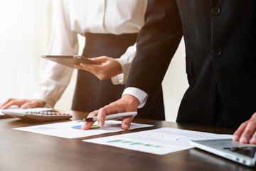 business people holding tablet and smartphone with meeting and brainstorming in planning work.