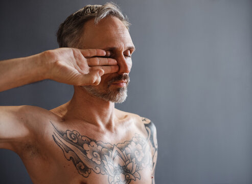 Bearded male meditating with Gyan mudra near face