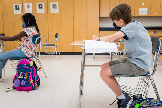 Boy in a classroom with mask during COVID-19