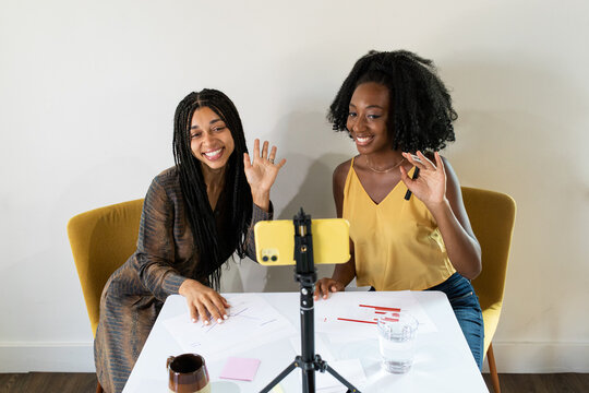 Female Entrepreneurs Wave During A Video Call.