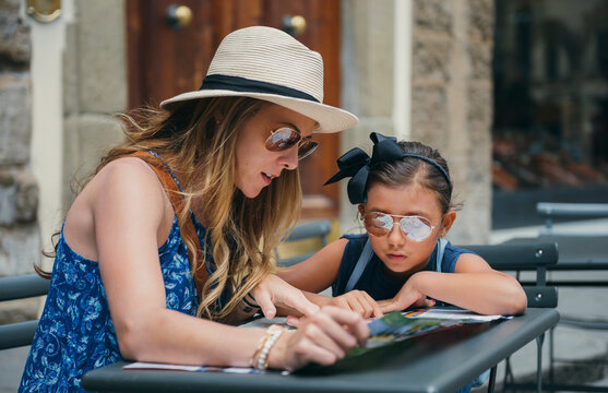 Mother and daughter looking at a map to visit sites throughout Florence