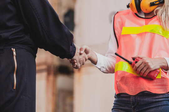 Worker Staff Shaking Hand For Sucess Working At Container. Workers Prepare Export Products. Container Shipping Logistics Engineering Of Import Export Transportation Industry