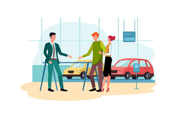 Salesman talking to a young couple at the dealership showroom.