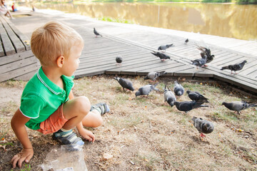 Side view of happy kid observing birds in park