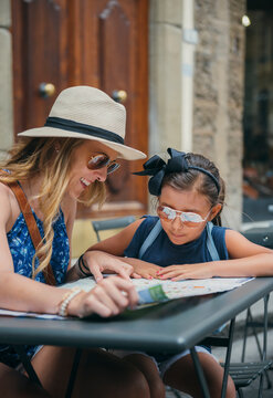 Mother and daughter looking at a map to visit sites throughout Florence