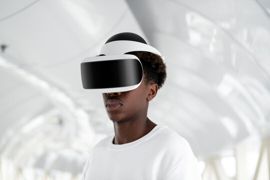 Fototapeta Man wearing a VR headset in a white tunnel futuristic technology