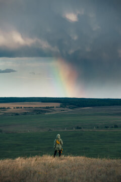 Unidentified woman watching rainbow rays in the sky