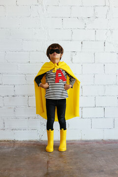 Confident boy in superhero costume
