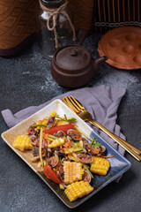 Spicy Cockles Salad with Corn in a Black Table Top Plate
