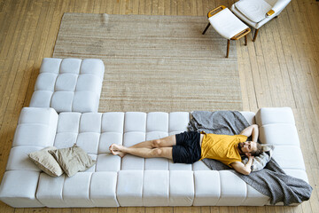 Man resting on sofa at home