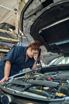 Female Auto Mechanic Working on a Vehicle
