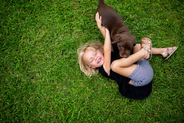 Little Girl Playing With Puppy
