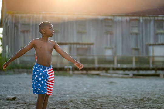 Boy in swimsuit swinging arms