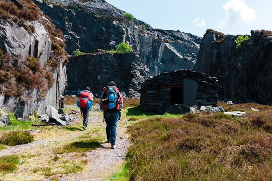 Hikers with backpacks near slate quarry