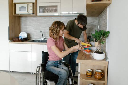Young couple working together in the kitchen preparing a meal