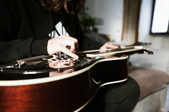 Playing a dobro guitar at home
