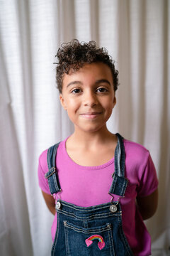 Girl with short curly hair looks smug