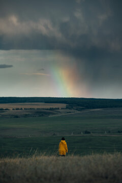 Unidentified woman watching rainbow rays in the sky